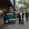 Lực lượng chức năng phường Giảng Võ (Ba Đình) xử lý cửa hàng kinh doanh ăn uống vi phạm vỉa hè trên địa bàn. (Ảnh: Mạnh Khánh/TTXVN)
