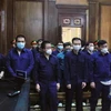 13 cựu cán bộ Công an phường Phú Thọ Hòa tại tòa. (Ảnh: Thành Chung/TTXVN)