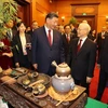 Tổng Bí thư Nguyễn Phú Trọng và Tổng Bí thư, Chủ tịch nước Trung Quốc Tập Cận Bình nghe giới thiệu về trà. (Ảnh: Trí Dũng/TTXVN)