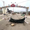 Tuyến đường Hùng Vương (thị trấn Khe Sanh, huyện Hướng Hoá) bị các hộ dân dùng các vật dụng và cành cây rào chắn, gây khó khăn cho việc lưu thông. (Ảnh: Nguyên Linh/TTXVN)