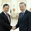 Chủ tịch nước Tô Lâm với Thủ tướng Campuchia Hun Manet. (Ảnh: Nhan Sáng/TTXVN)