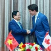 Thủ tướng Phạm Minh Chính gặp Thủ tướng Canada Justin Trudeau. (Ảnh: Dương Giang/TTXVN)