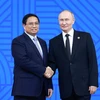 Tổng thống Liên bang Nga Vladimir Putin, Chủ tịch Nhóm BRICS năm 2024 đón Thủ tướng Phạm Minh Chính. (Ảnh: Dương Giang/TTXVN)