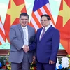 Thủ tướng Chính phủ Phạm Minh Chính với Chủ tịch Hạ viện Malaysia Tan Sri Dato’ Johari Bin Abdul. (Ảnh: Phạm Kiên/TTXVN)