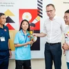 Phó Đại sứ Simon Kreye (thứ 3 từ trái qua) tặng quà cho Đội tuyển Nữ Việt Nam. (Ảnh: GermanEmbassyHanoi)