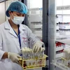 Nhân viên y tế kiểm tra các sinh phẩm được bảo quản tại Ngân hàng gen vi sinh vật - Bệnh viện Bệnh Nhiệt đới Trung ương. (Ảnh: Dương Ngọc/TTXVN)