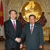 Chủ tịch nước Trần Đại Quang và Tổng Bí thư, Chủ tịch nước Lào Bounnhang Volachith tại lễ đón. (Ảnh: Nhan Sáng/TTXVN)