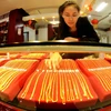 Trang sức bằng vàng được bày bán tại một cửa hàng ở tỉnh Sơn Đông, Trung Quốc. (Nguồn; AFP/TTXVN)