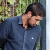 Cảnh sát áp giải đối tượng Salah el Karib tới phiên tòa ở Madrid, Tây Ban Nha ngày 22/8. (Nguồn: EPA/TTXVN)