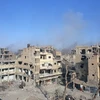 Khói bốc lên sau một cuộc không kích nhằm vào IS tại Deir al-Zour, Syria hồi đầu năm. (Nguồn: AFP/TTXVN)