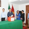Các cán bộ, nhân viên Đại sứ quán Việt Nam và các cơ quan đại diện Việt Nam bên cạnh Đại sứ quán tại Mexico quyên góp ủng hộ nhân dân Lào. (Ảnh: Việt Hùng/TTXVN)