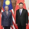 Chủ tịch Trung Quốc Tập Cận Bình (phải) và Thủ tướng Malaysia Mahathir Mohamad trong cuộc gặp tại Bắc Kinh ngày 20/8. (Ảnh: THX/TTXVN)