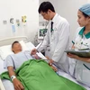 Bác sỹ đang kiểm tra sức khỏe cho bệnh nhân N sau khi được cấp cứu thành công. (Ảnh: Kiều Oanh/Vietnam+) 