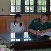 Lực lượng chức năng bàn giao hai thiếu nữ 16 tuổi bị lừa bán sang Trung Quốc. (Ảnh: Nguyễn Hoàng/TTXVN)