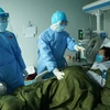 Bệnh nhân nhiễm COVID-19 được điều trị tại bệnh viện dã chiến ở Vũ Hán, tỉnh Hồ Bắc, Trung Quốc, ngày 17/3/2020. (Ảnh: THX/ TTXVN)