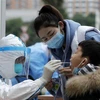 Nhân viên y tế lấy mẫu xét nghiệm COVID-19 tại Thành Đô, tỉnh Tứ Xuyên, Trung Quốc. (Ảnh: THX/TTXVN)