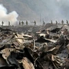Lực lượng Phòng vệ Nhật Bản tìm kiếm nạn nhân tại khu vực bị tàn phá sau thảm họa động đất sóng thần ở tỉnh Iwate, Nhật Bản ngày 13/3/2011. (Ảnh: AFP/TTXVN)