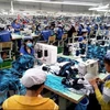 Sản xuất hàng may mặc xuất khẩu tại Công ty may mặc New Apparel, Khu công nghiệp Bắc Đồng Phú, tỉnh Bình Phước. (Ảnh: Dương Chí Tưởng/TTXVN)