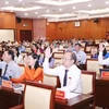 Đại biểu Hội đồng Nhân dân Thành phố Hồ Chí Minh biểu quyết thông qua 51 Nghị quyết của Kỳ họp thứ 20. (Ảnh: Xuân Khu/TTXVN)