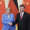 Chủ tịch Trung Quốc Tập Cận Bình và Thủ tướng Đức Angela Merkel. (Ảnh: AFP) 