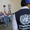 Người di tản bỏ phiếu trong cuộc bầu cử lập pháp tại điểm bầu cử ở Arbil, Iraq, ngày 8/10/2021. (Ảnh: AFP/ TTXVN)