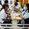 Nhân viên y tế Nam Phi kiểm tra thân nhiệt trước khi được tiêm vaccine ngừa COVID-19 tại bệnh viện ở Umlazi, phía Nam Durban. (Ảnh: AFP/TTXVN)