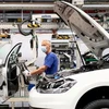 Công nhân làm việc trên dây chuyền lắp ráp xe ôtô của Hãng Volkswagen ở Wolfsburg (Đức). (Ảnh: Reuters/TTXVN)