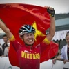 Khoảnh khắc hạnh phúc của VĐV Đinh Thị Như Quỳnh khi cô giơ cao lá cờ Tổ quốc.(Ảnh: Trọng Đạt/TTXVN)