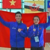 Hai vận động viên Việt Nam đoạt Huy chương Vàng nội dung Seni-Pencak Silat Nguyễn Thành Long và Hoàng Linh Đan. (Ảnh: Văn Dũng/TTXVN)