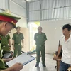 Cơ quan Cảnh sát điều tra, Công an tỉnh Cà Mau đọc quyết định bắt tạm giam bị can Nguyễn Quốc Nhân. (Ảnh: TTXVN phát)