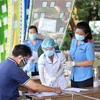 Khai báo y tế tại tỉnh Tây Ninh. (Ảnh: Thanh Tân/TTXVN)