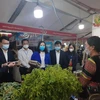 Lãnh đạo Sở Công Thương Hà Nội và quận Hà Đông đi thăm quan một gian hàng tại hội chợ. (Ảnh: Phương Anh/TTXVN)