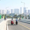 Người dân di chuyển trên Cầu Phước Lộc - dự án có tổng mức đầu tư 405 tỷ đồng tại huyện Nhà Bè (Thành phố Hồ Chí Minh). (Ảnh: Tiến Lực/TTXVN)