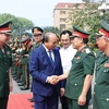 Chủ tịch nước Nguyễn Xuân Phúc đến thăm và làm việc tại Bộ Tư lệnh Quân khu 1, chiều 25/4/2022. (Ảnh: Thống Nhất/TTXVN)