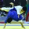 Chu Đức Đạt (xanh) giành chiến thắng trước đối thủ Sithisane Soukphaxay của Lào ở hạng cân dưới 60kg, đoạt huy chương Vàng. (Ảnh: Quang Quyết/TTXVN)