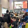 Hành khách tại sân bay Tân Sơn Nhất. (Ảnh: Tiến Lực/TTXVN)