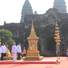 Quốc Vương Norodom Sihamoni, Thủ tướng Hun Sen và các đại biểu thực hiện nghi thức tại Lễ xin lửa và khởi động hoạt động rước đuốc cho SEA Games 32 và ASEAN Para Games 12 trước Đền Angkor Wat tại tỉnh Siem Reap (Vương quốc Campuchia), ngày 21/3/2023. (Ảnh