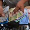 Đồng tiền rupiah của Indonesia. (Ảnh minh họa: AFP/TTXVN)Đồng tiền rupiah của Indonesia. (Ảnh minh họa: AFP/TTXVN)