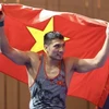 Cấn Tất Dự giành huy chương Vàng môn Vật ở hạng cân 74kg Nam, đây là huy chương Vàng thứ 135 của Đoàn Thể thao Việt Nam tại SEA Games 32. (Ảnh: Minh Quyết/TTXVN)