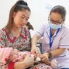 Tiêm vaccine dịch vụ tại Trạm Y tế xã Phong Phú, huyện Bình Chánh (Thành phố Hồ Chí Minh). (Ảnh: Đinh Hằng/TTXVN)