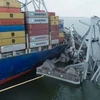 Hiện trường vụ tàu container Dali đâm sập cầu ở cảng Baltimore hôm 26/3. (Ảnh: AFP/TTXVN)