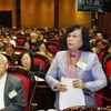 Bộ trưởng Bộ Lao động-Thương binh và Xã hội Phạm Thị Hải Chuyền trả lời các câu hỏi của đại biểu Quốc hội. (Ảnh: Lâm Khánh/TTXVN)
