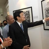 Chủ tịch nước Trương Tấn Sang đến thăm triển lãm ảnh "Việt Nam - Cuộc chiến tranh qua ảnh" của Hãng Thông tấn AP, Hoa Kỳ. (Ảnh: Nguyễn Khang/TTXVN)