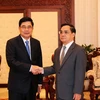 Thủ tướng Lào Thongsing Thammavong tiếp Bộ trưởng Cao Đức Phát. (Ảnh: Phạm Kiên/Vietnam+)