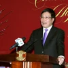 Phó Thủ tướng, Bộ trưởng Bộ Ngoại giao Phạm Bình Minh phát biểu chúc mừng các nhà báo tại buổi gặp mặt. (Ảnh: Nguyễn Dân/TTXVN)