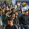Người tị nạn xuống tàu ở nhà ga Munich, Đức. (Nguồn: AFP).