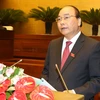 Thủ tướng Nguyễn Xuân Phúc trình bày Báo cáo trước Quốc hội. (Ảnh: Thống Nhất/TTXVN)