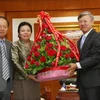 Bà Sounthone Sayachak trao lẵng hoa chúc mừng Quốc khánh Việt Nam cho Đại sứ Việt Nam tại Lào Nguyễn Mạnh Hùng. (Ảnh: Phạm Kiên/TTXVN)