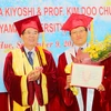 Phó giáo sư, tiến sỹ Nguyễn Văn Toàn, Gám đốc Đại học Huế trao bằng "Giáo sư danh dự" cho giáo sư Doo-Chul Kim. (Ảnh: Hồ Cầu/TTXVN)