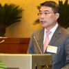 Thống đốc Ngân hàng Nhà nước Lê Minh Hưng trình bày Tờ trình dự án Luật sửa đổi, bổ sung một số điều của Luật các tổ chức tín dụng. (Ảnh: Doãn Tấn/TTXVN)